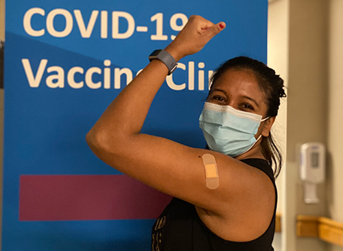 Rina Patel displays arm after receiving vaccine