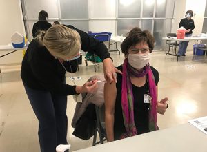 Roberta Delrosso, RN receiving the COVID-19 vaccine